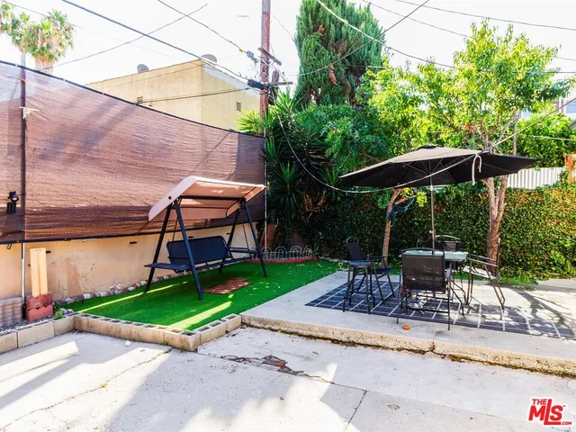 a view of a table and chairs under an umbrella