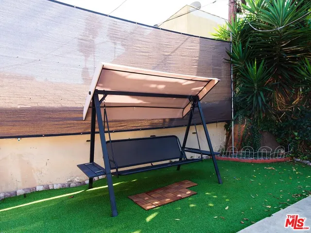 a view of a backyard with sitting area