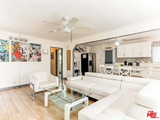 a living room with furniture and kitchen view