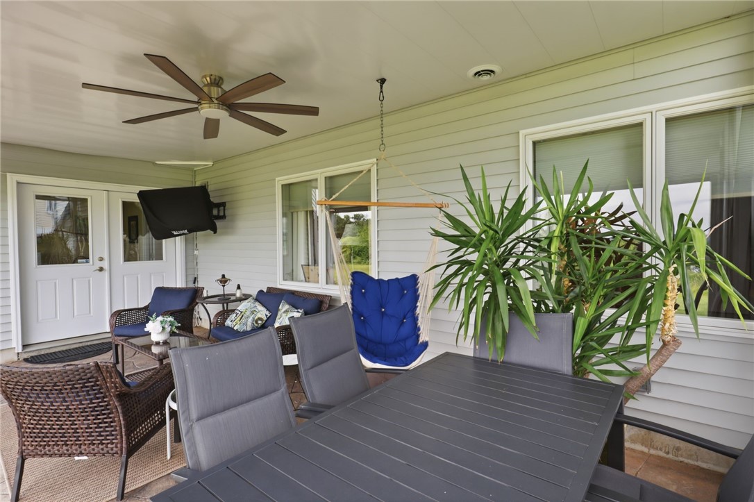 4536 Crystal Ridge Circle Gorham, NY 14424 - Photo 36 of 48 The lower-level patio features a lighted ceiling fan, an outdoor TV, and space for outdoor dining.