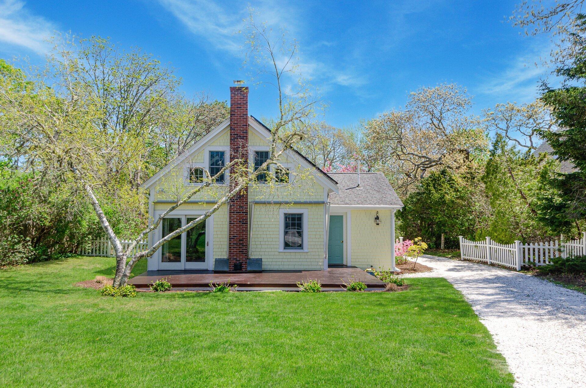 1089 Main Street Cotuit, MA 02635 - Photo 25 of 41 a view of a house with a big yard potted plants and large tree
