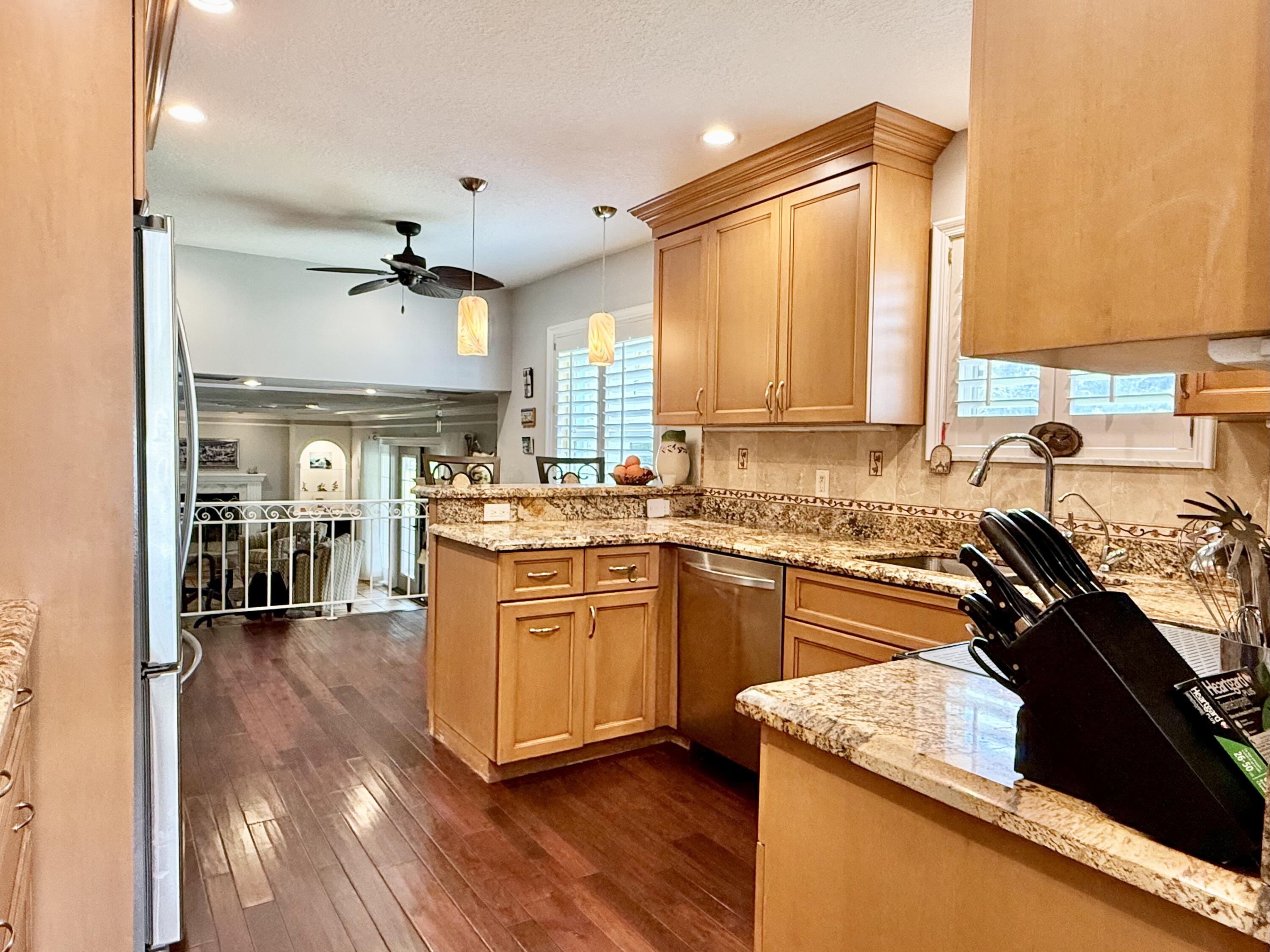 16283 Alexander Run Jupiter, FL 33478 - Photo 21 of 96 a kitchen with stainless steel appliances granite countertop a sink stove and refrigerator