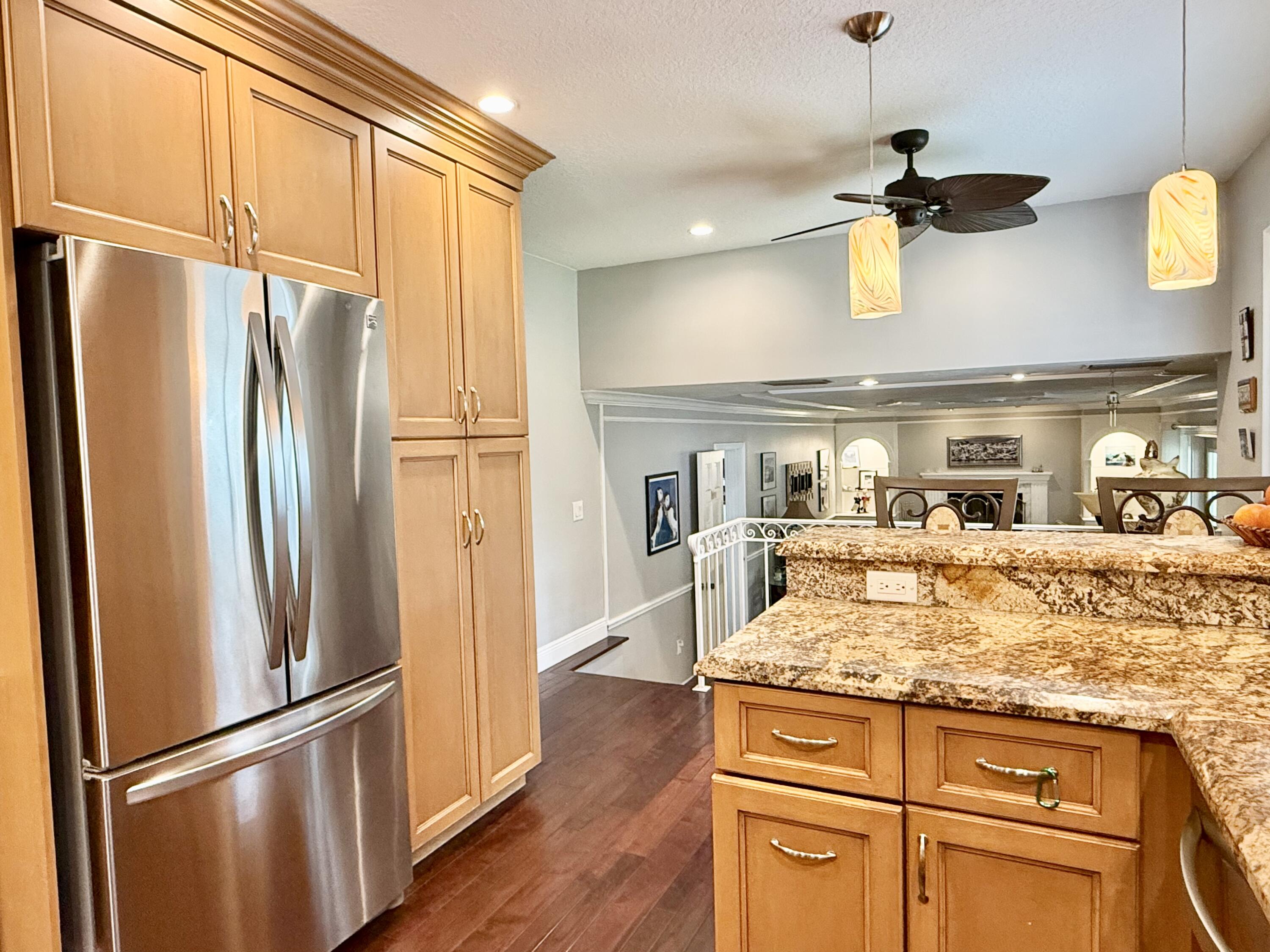 16283 Alexander Run Jupiter, FL 33478 - Photo 27 of 96 a kitchen with stainless steel appliances granite countertop a refrigerator and microwave