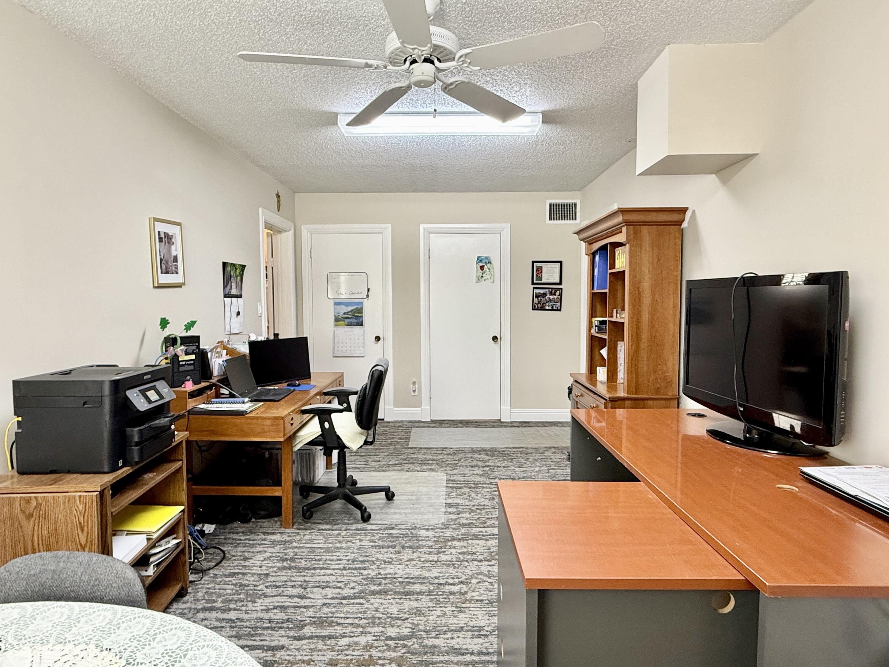 16283 Alexander Run Jupiter, FL 33478 - Photo 32 of 96 a workspace with furniture and wooden floor