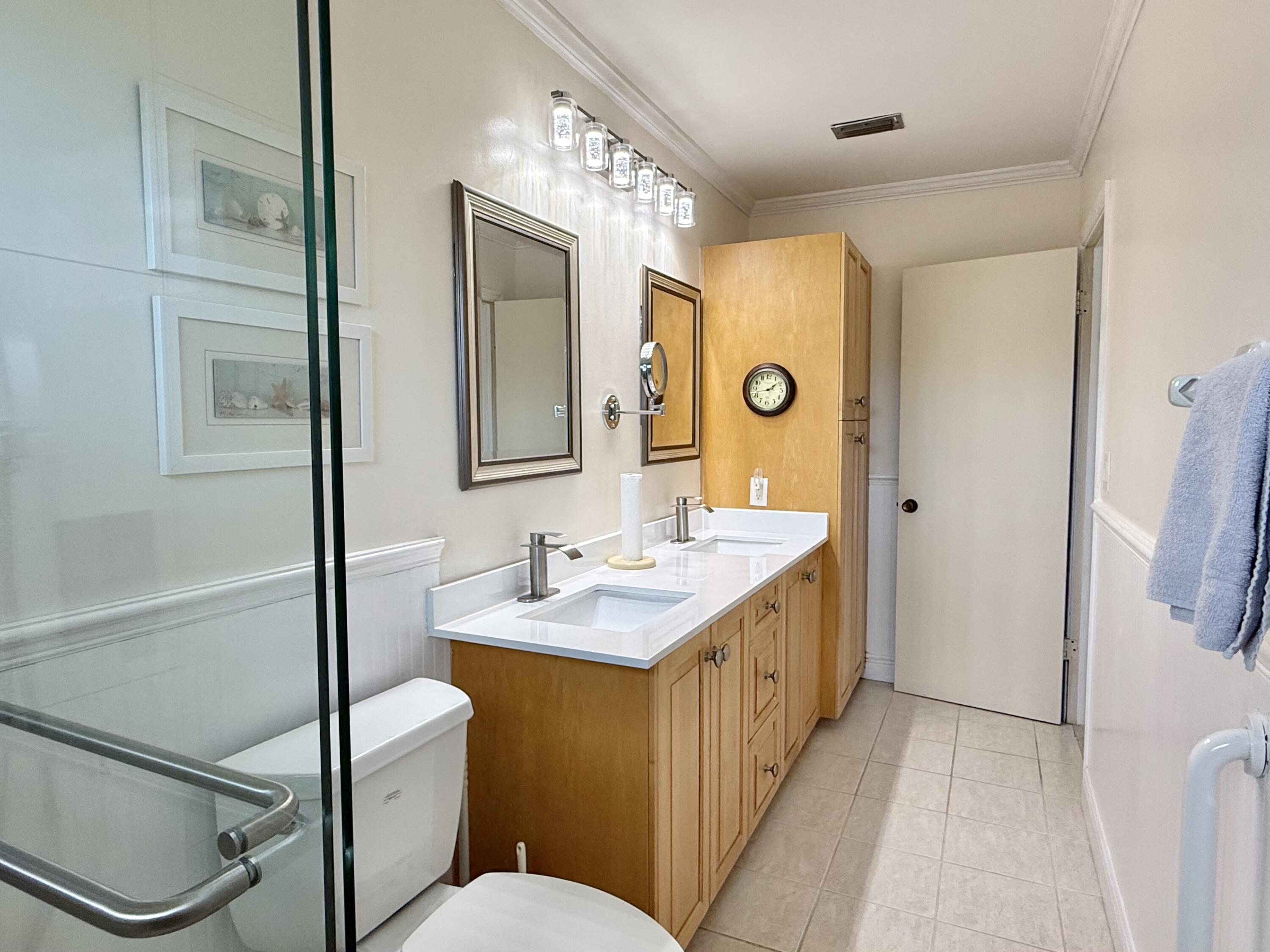16283 Alexander Run Jupiter, FL 33478 - Photo 41 of 96 a bathroom with a sink a toilet a mirror and shower