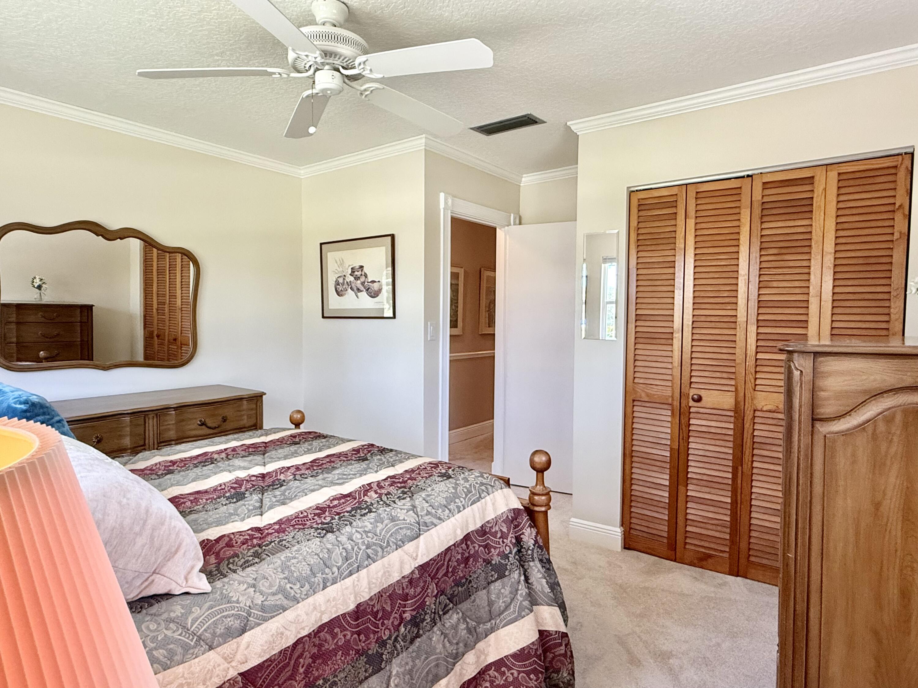 16283 Alexander Run Jupiter, FL 33478 - Photo 44 of 96 a bedroom with a bed and wooden floor