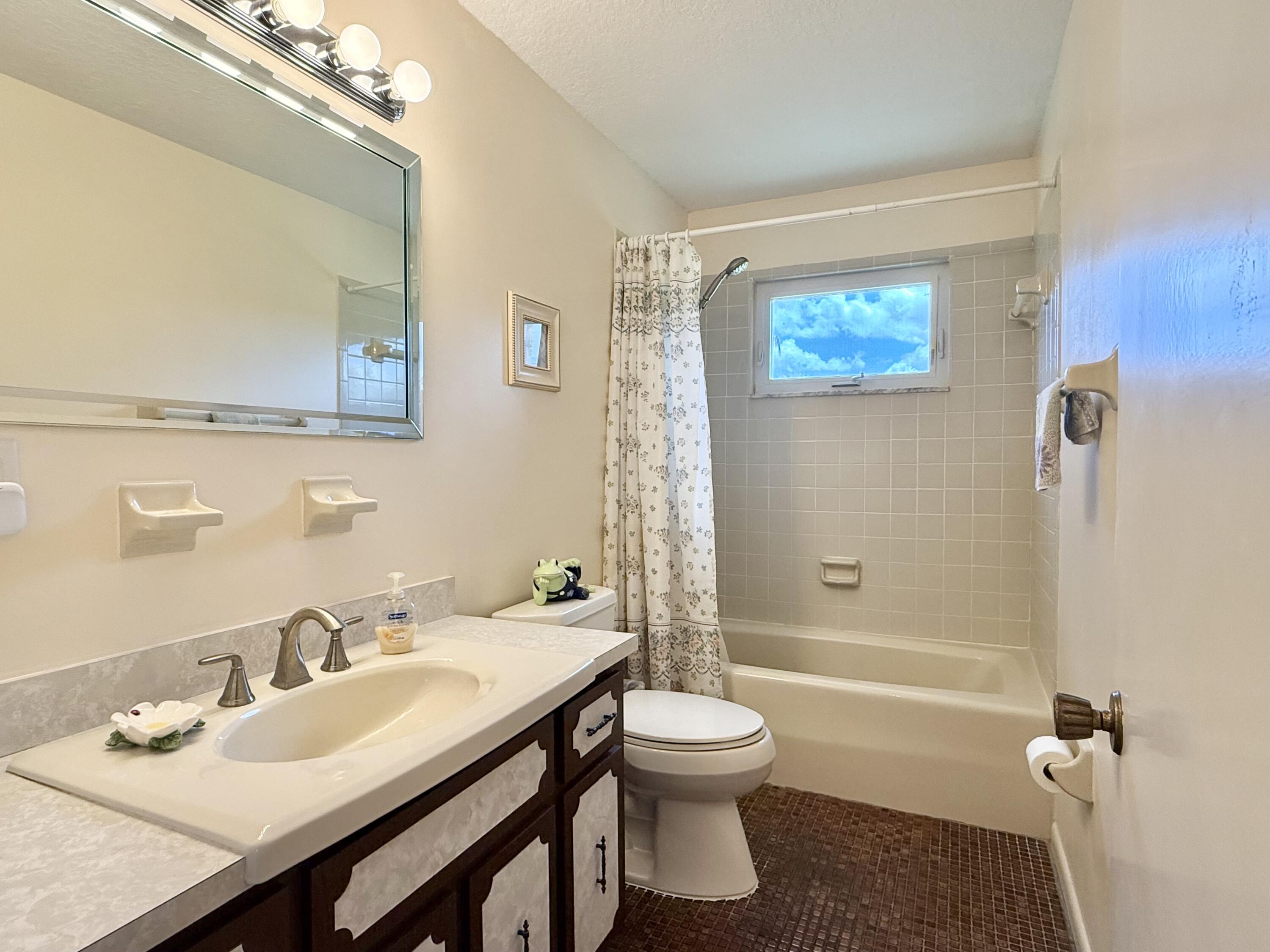 16283 Alexander Run Jupiter, FL 33478 - Photo 49 of 96 a bathroom with a sink toilet and shower