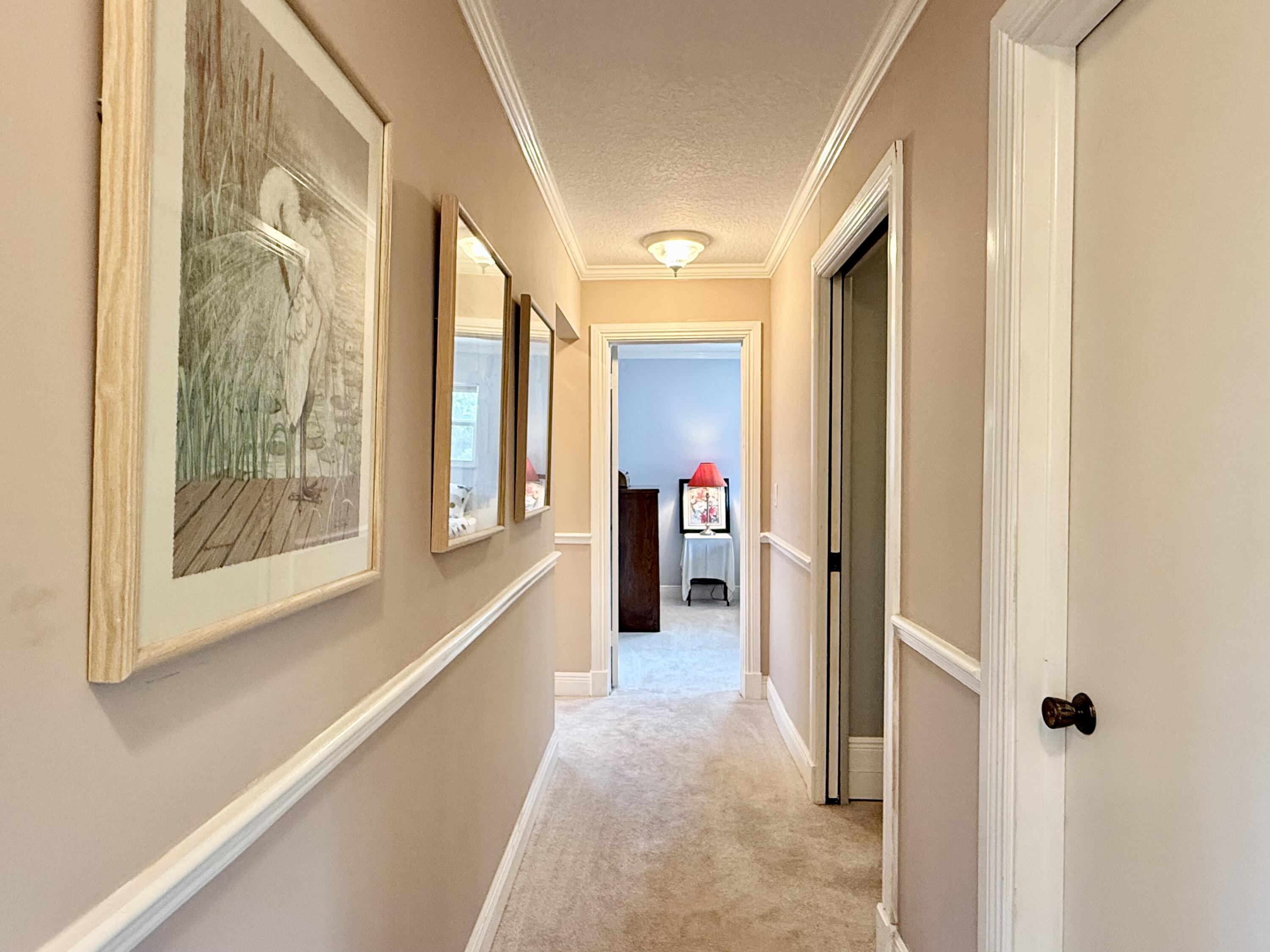 16283 Alexander Run Jupiter, FL 33478 - Photo 53 of 96 a view of a hallway with wooden floor and windows