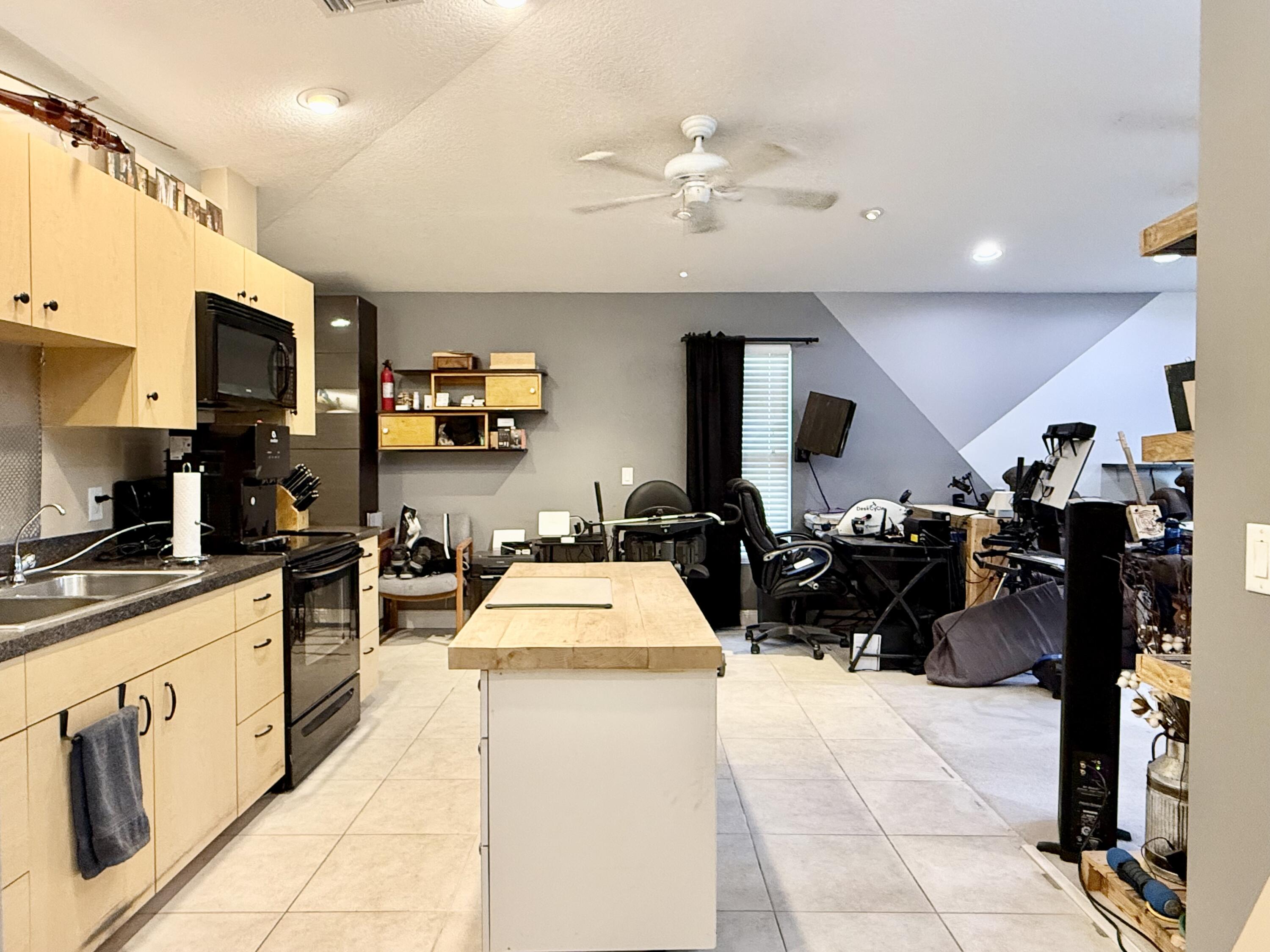 16283 Alexander Run Jupiter, FL 33478 - Photo 64 of 96 a kitchen with stainless steel appliances kitchen island granite countertop a sink and cabinets