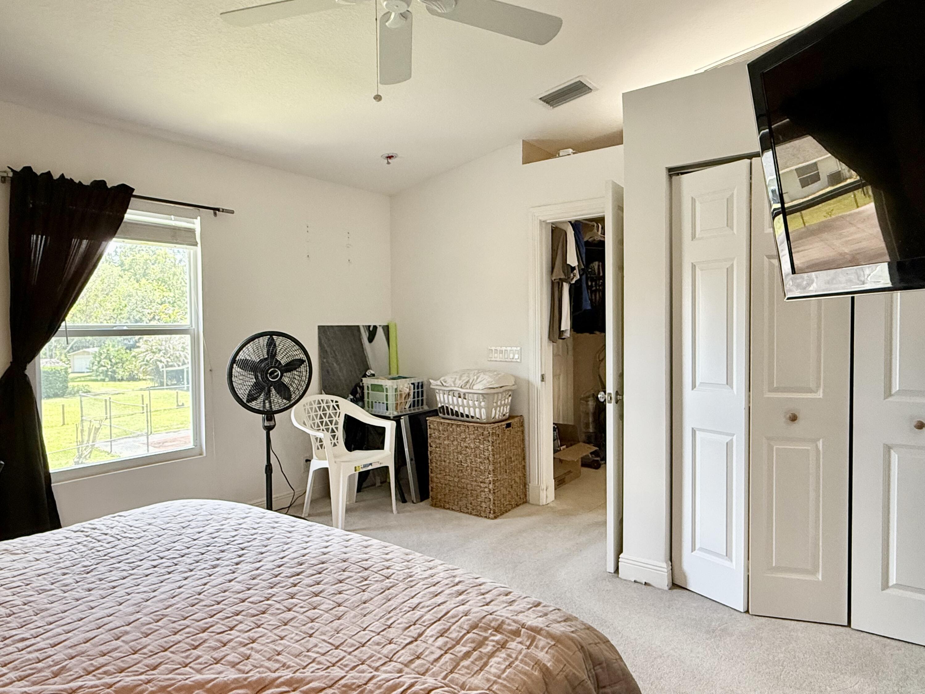 16283 Alexander Run Jupiter, FL 33478 - Photo 73 of 96 a bedroom with a bed and a window
