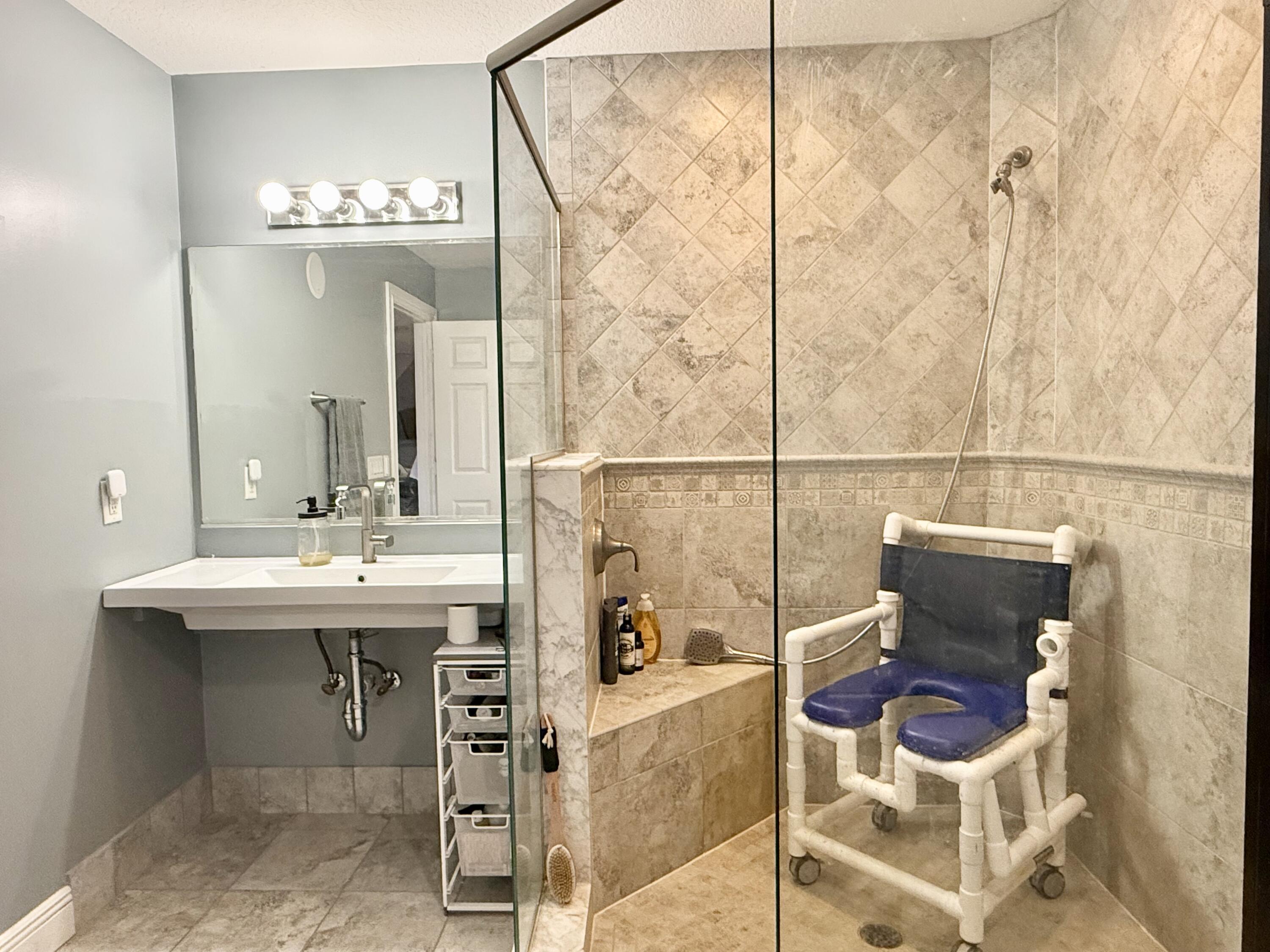 16283 Alexander Run Jupiter, FL 33478 - Photo 76 of 96 a bathroom with a sink and a mirror