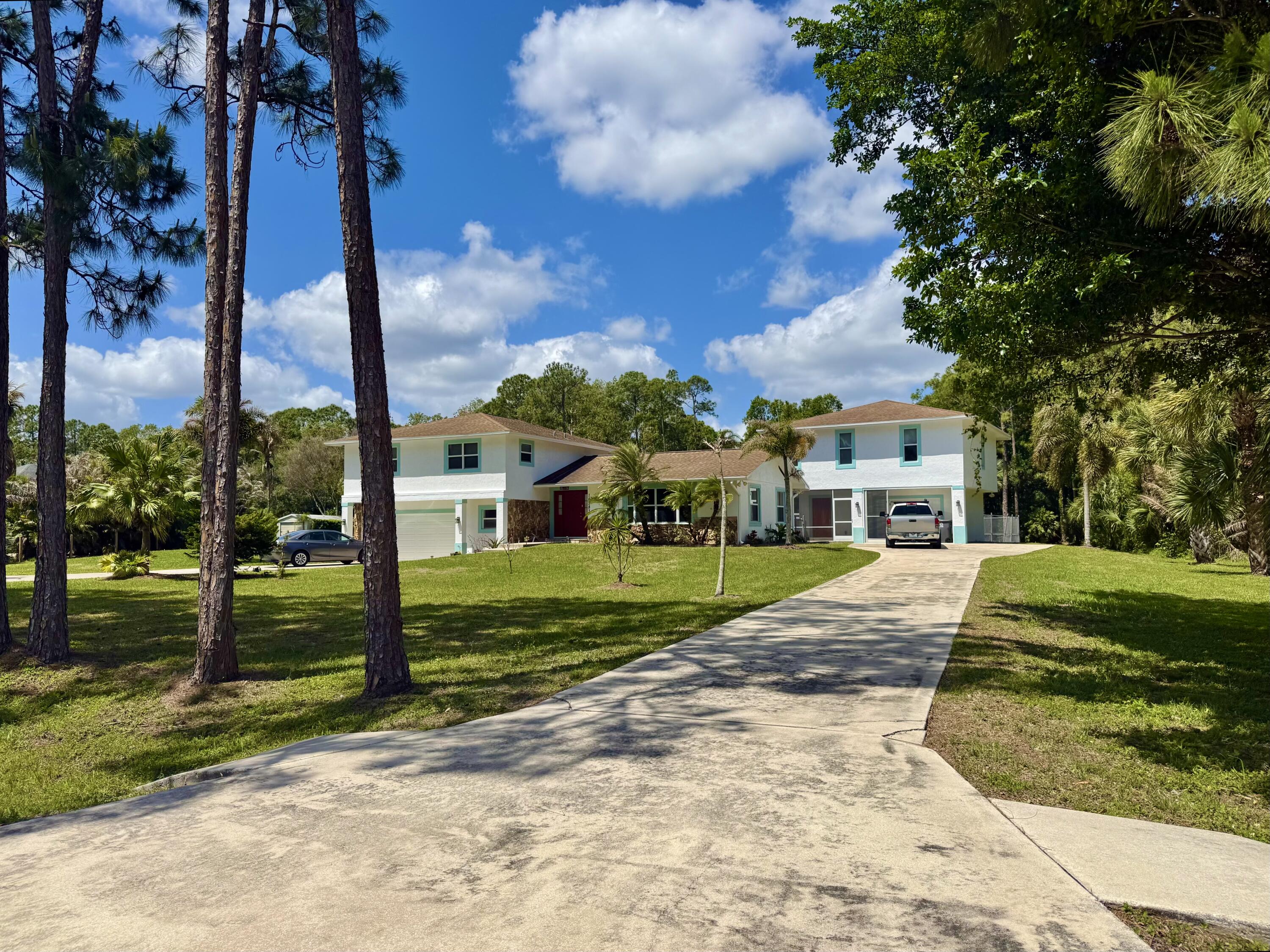 16283 Alexander Run Jupiter, FL 33478 - Photo 85 of 96 a view of a house with a yard and tree s
