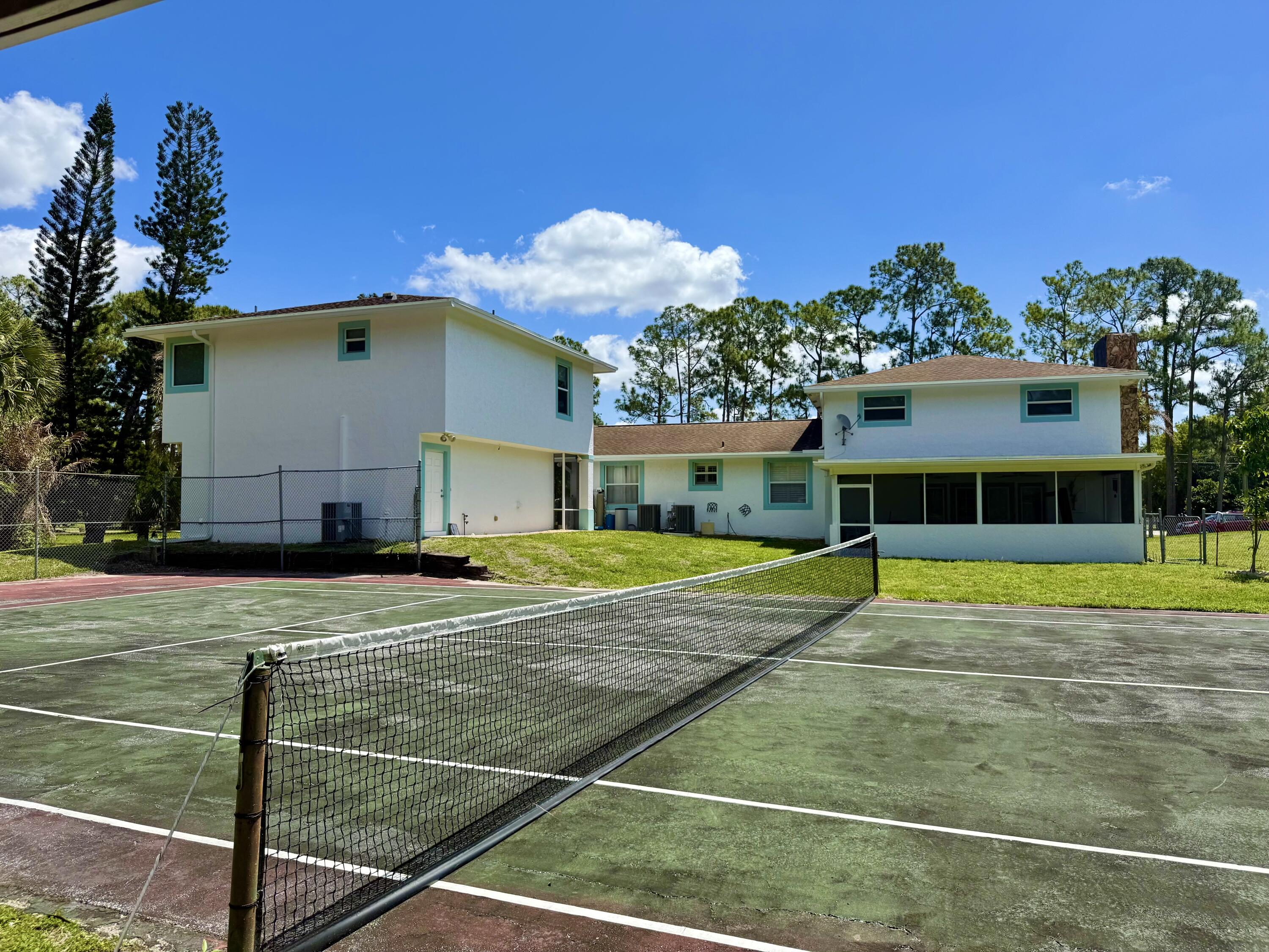 16283 Alexander Run Jupiter, FL 33478 - Photo 87 of 96 a view of a house with swimming pool and a yard