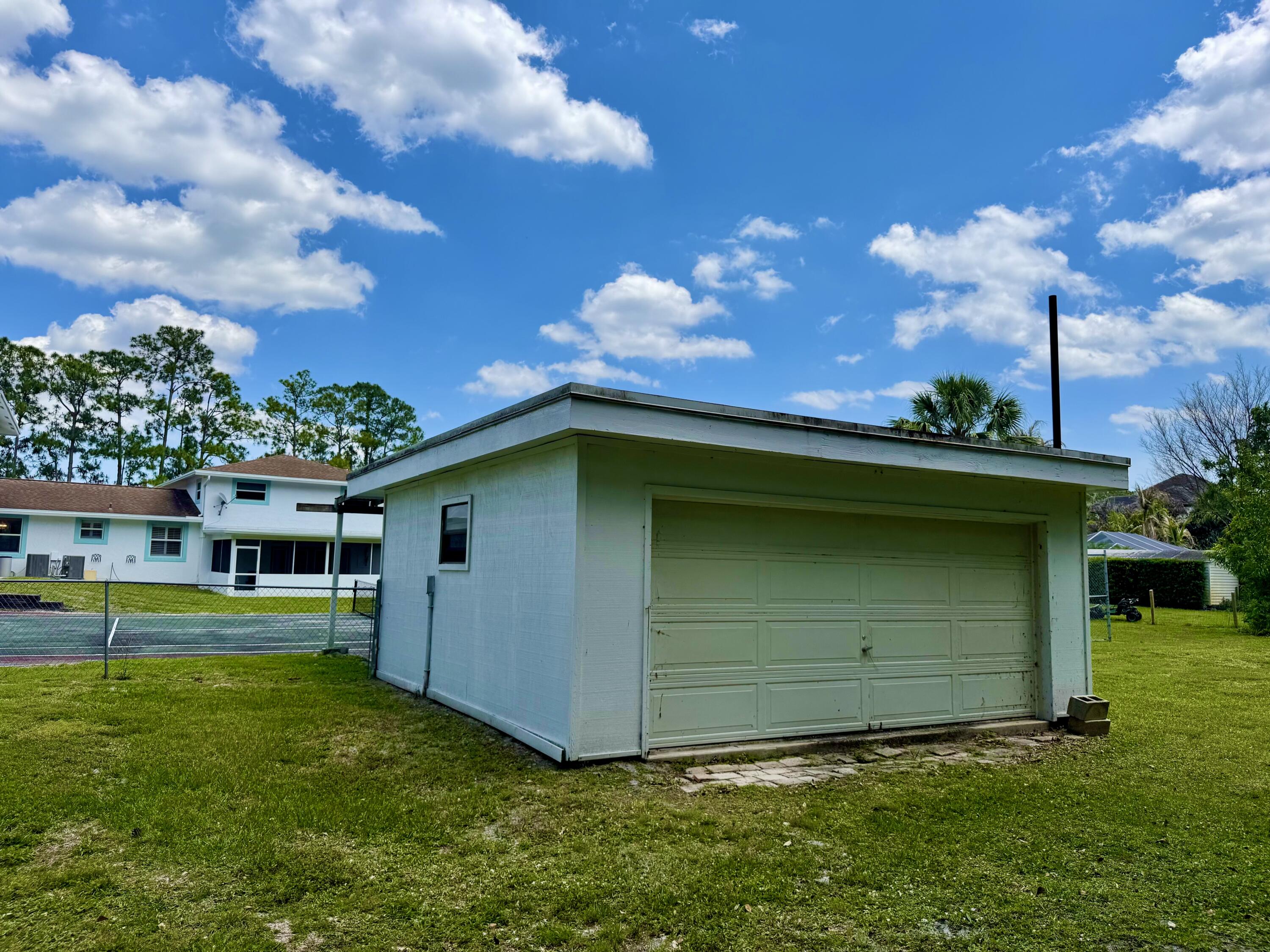 16283 Alexander Run Jupiter, FL 33478 - Photo 95 of 96 a view of a backyard with a garden