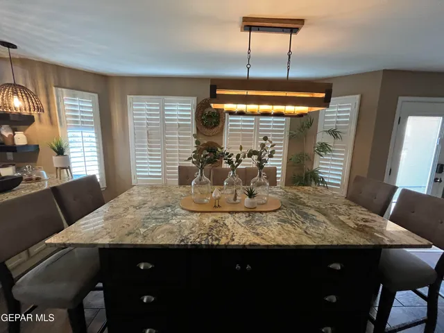 a kitchen with stainless steel appliances granite countertop sink stove top oven and cabinets