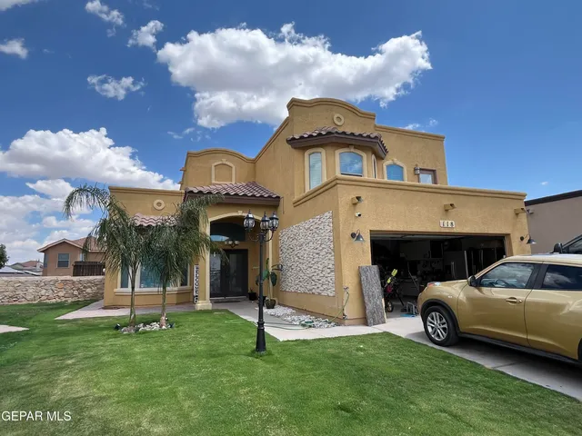a front view of a house with a garden