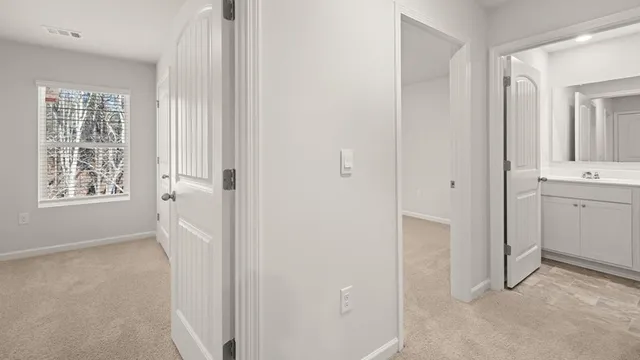a view of a bathroom with two sinks and a window