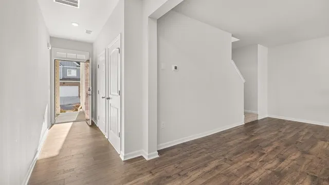 a view of a hallway with wooden floor