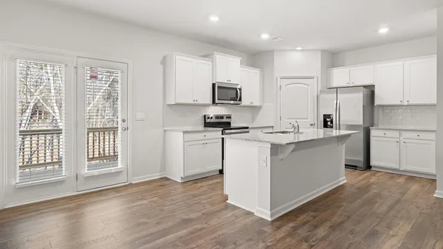 a kitchen with kitchen island white cabinets and white appliances