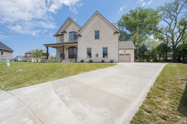 a view of a house with a yard and garage