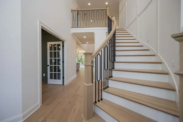 a view of entryway and hall with wooden floor