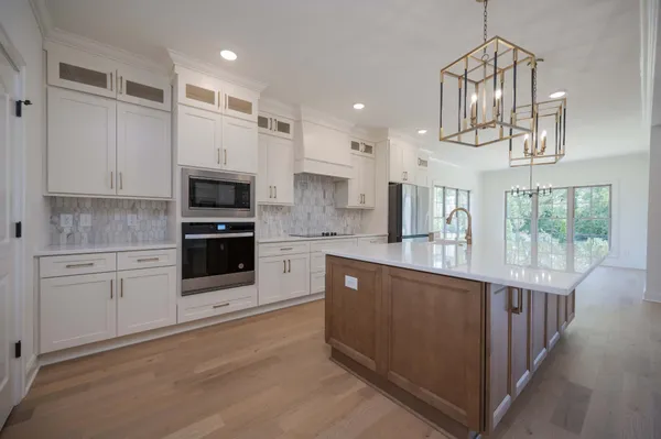 a kitchen with white cabinets and a sink