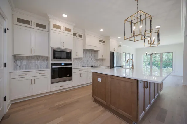 a kitchen with white cabinets and a sink