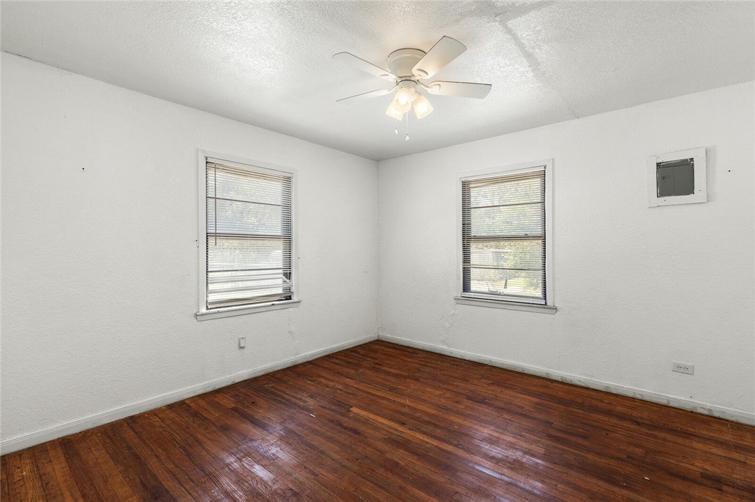 1211 South Old Robinson Road Robinson, TX 76706 - Photo 17 of 26 a view of an empty room with wooden floor and a window