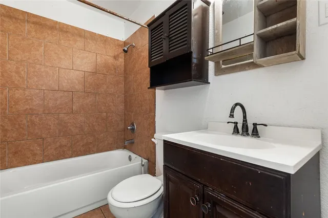 a bathroom with a sink a toilet and bathtub