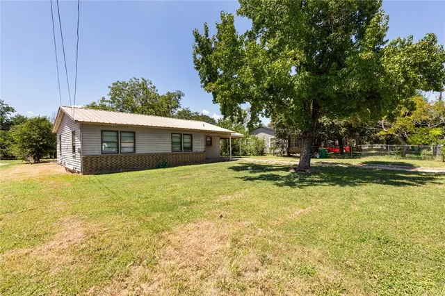 a view of a house with swimming pool and a yard