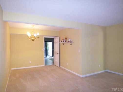 View of the Dining area which offers neutral carpet & brass chandelier. Other