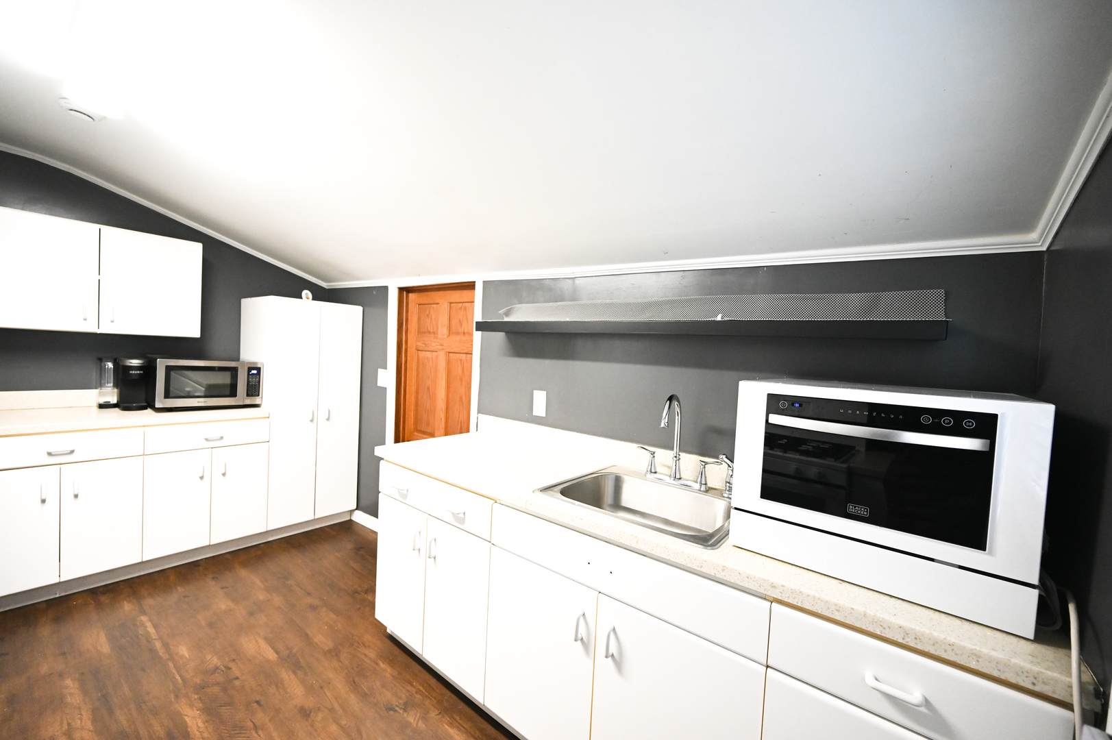 219 South 7th Street DeKalb, IL 60115 - Photo 18 of 30 a kitchen with a stove and a microwave