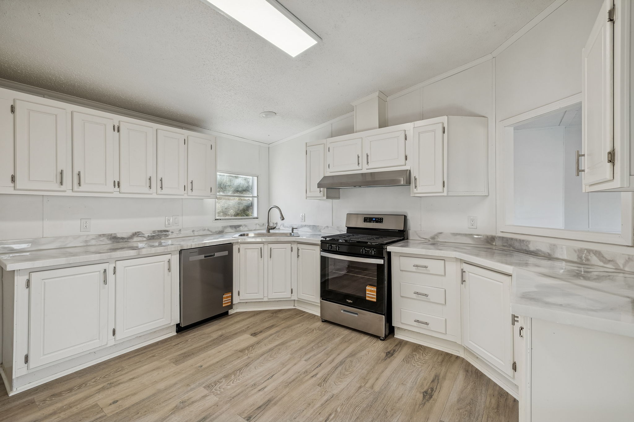 145 Milk Barn Road Cookeville, TN 38506 - Photo 11 of 43 a kitchen with granite countertop white cabinets and white appliances