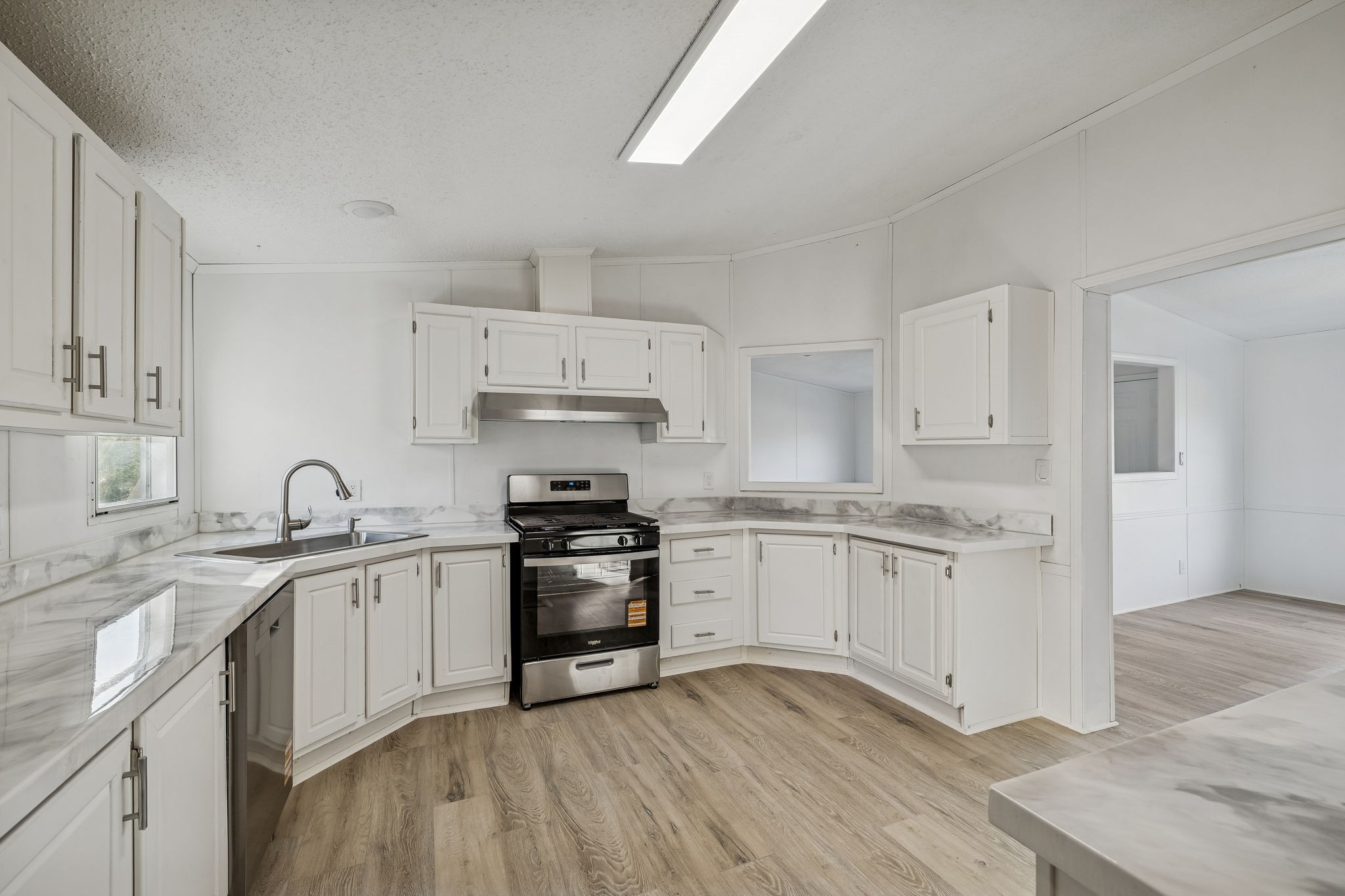 145 Milk Barn Road Cookeville, TN 38506 - Photo 12 of 43 a kitchen with granite countertop white cabinets and stainless steel appliances