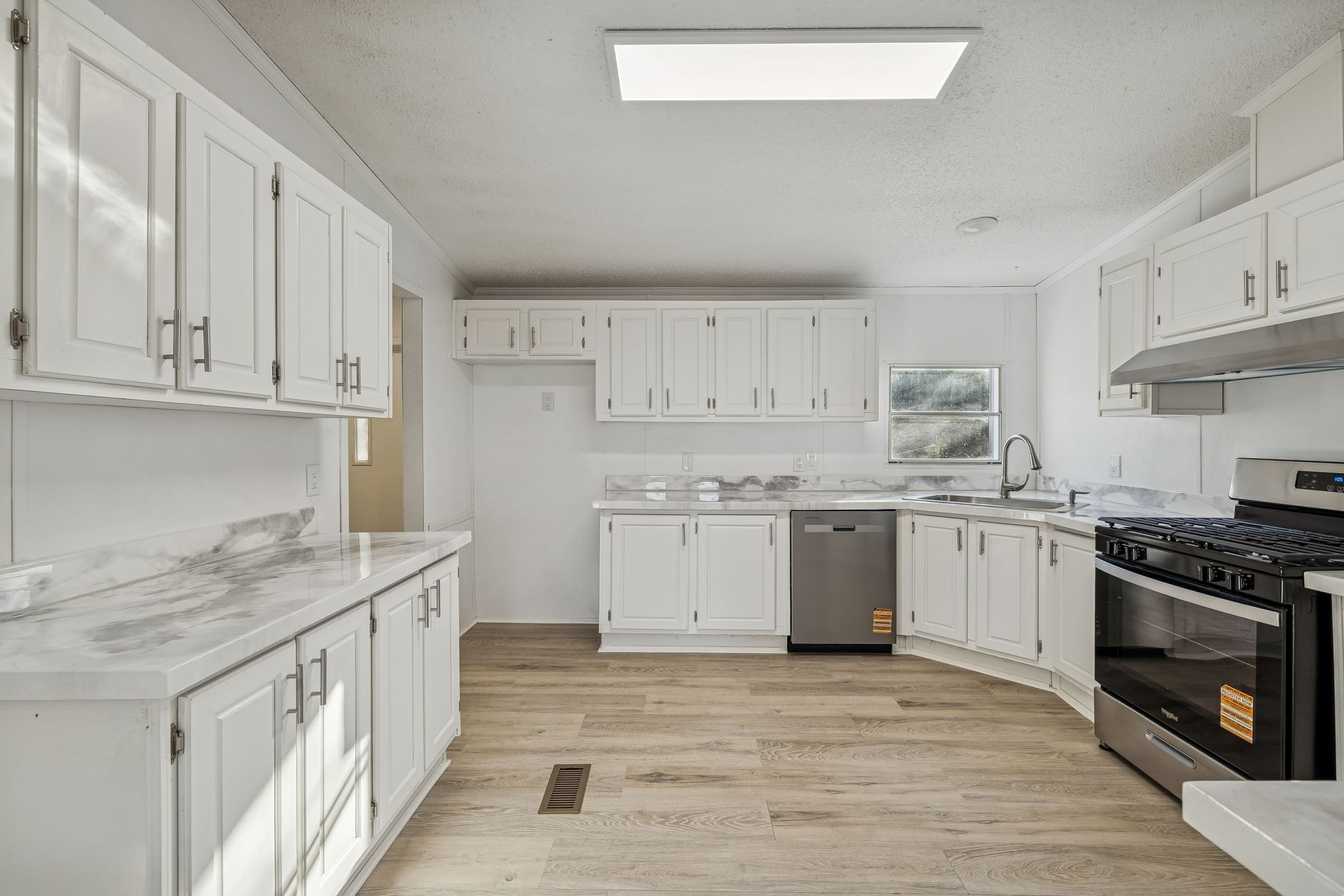 145 Milk Barn Road Cookeville, TN 38506 - Photo 14 of 43 a kitchen with stainless steel appliances granite countertop a stove a sink and white cabinets