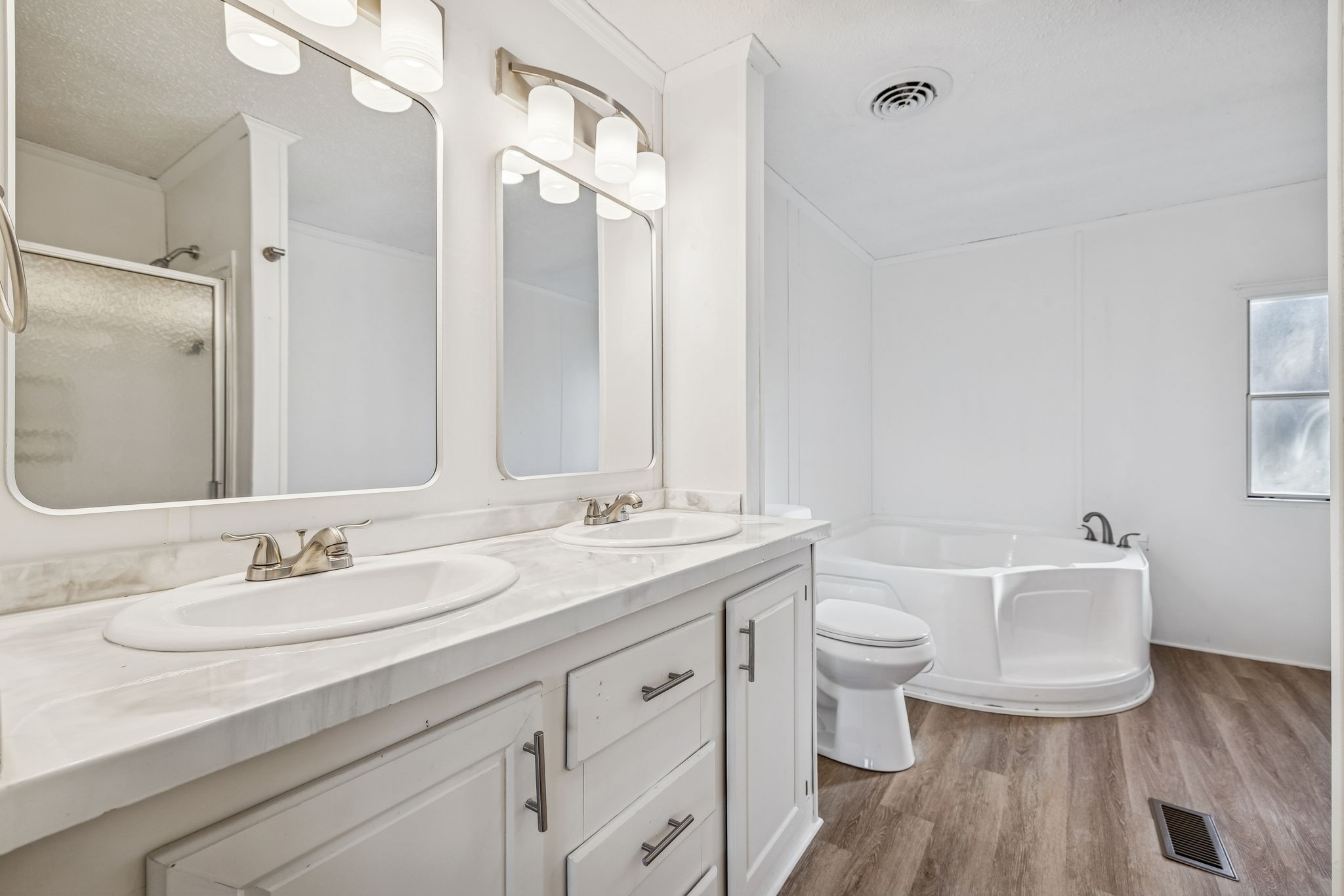 145 Milk Barn Road Cookeville, TN 38506 - Photo 20 of 43 a bathroom with a double vanity sink toilet and a mirror