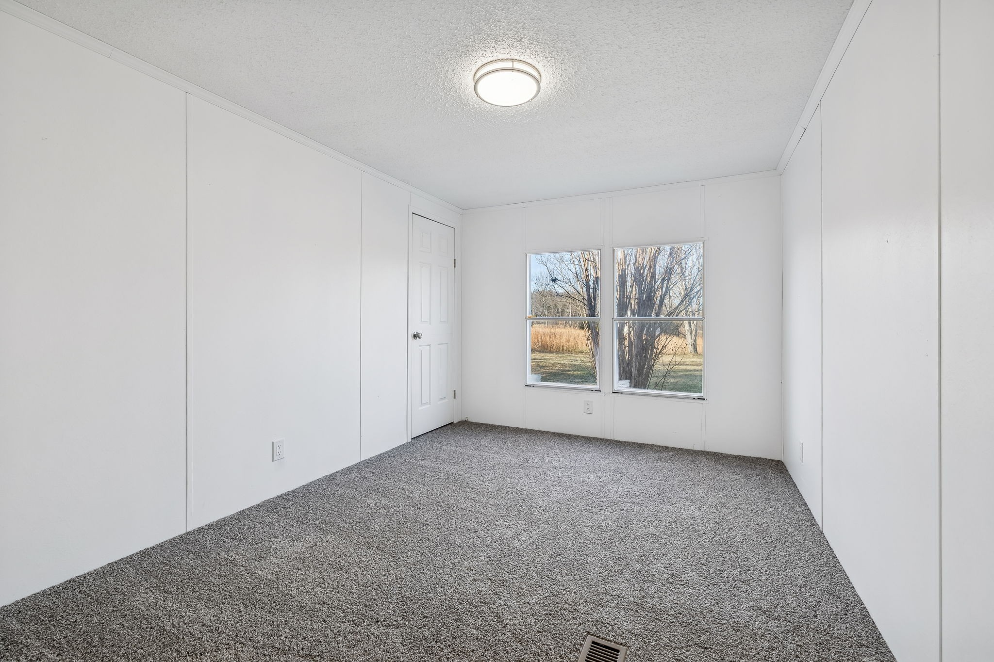 145 Milk Barn Road Cookeville, TN 38506 - Photo 24 of 43 an empty room with windows and mirror