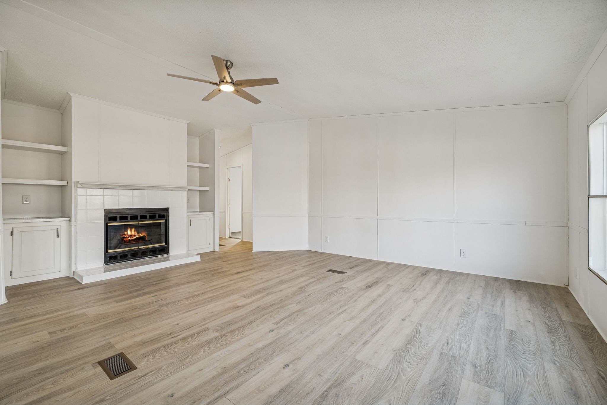 145 Milk Barn Road Cookeville, TN 38506 - Photo 5 of 43 wooden floor in an empty room with a fireplace