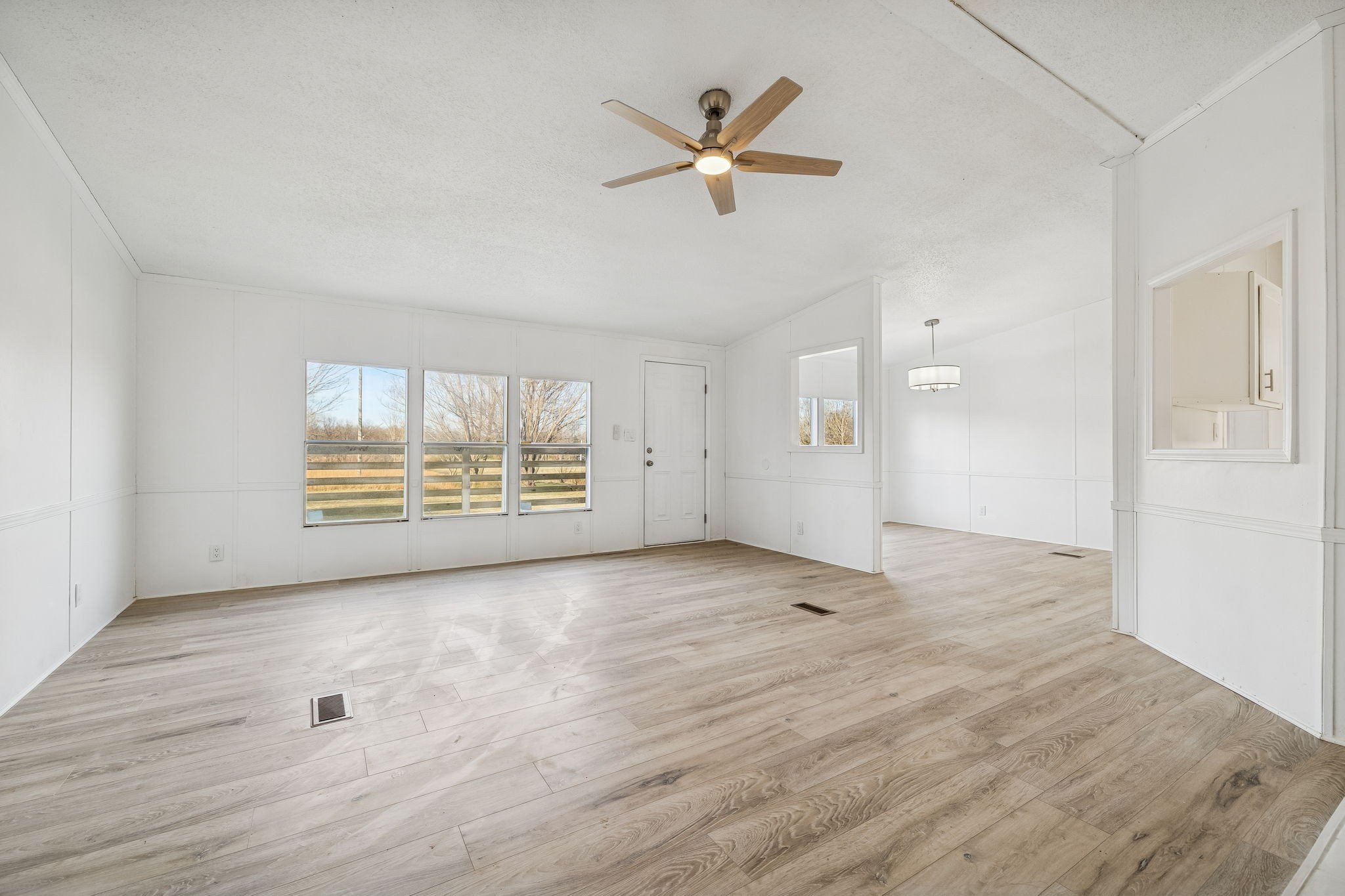 145 Milk Barn Road Cookeville, TN 38506 - Photo 7 of 43 an empty room with wooden floor and windows