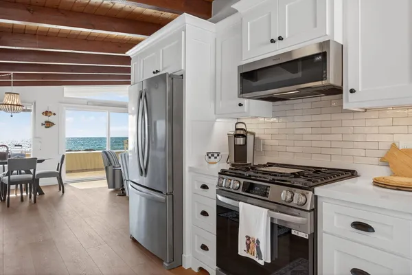 a kitchen with a sink stove and cabinets