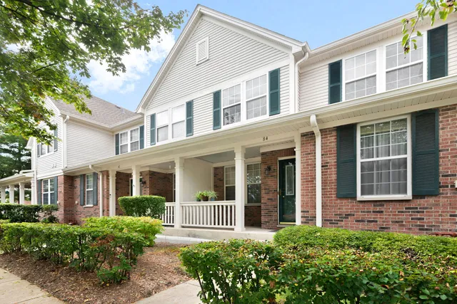 front view of a brick house with a large windows and a large window