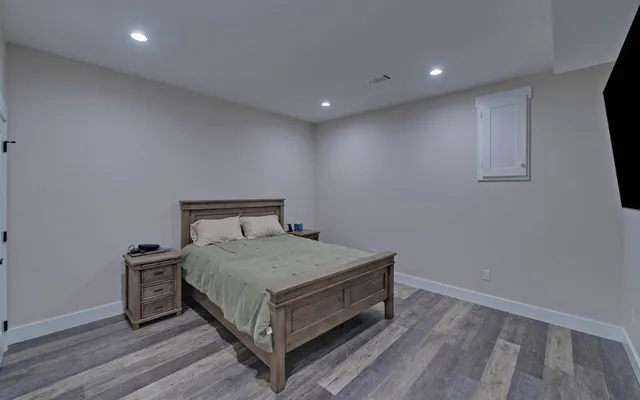 a bedroom with a bed and a window