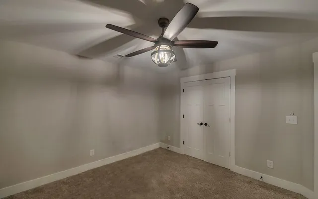 a view of walk in closet with clothes