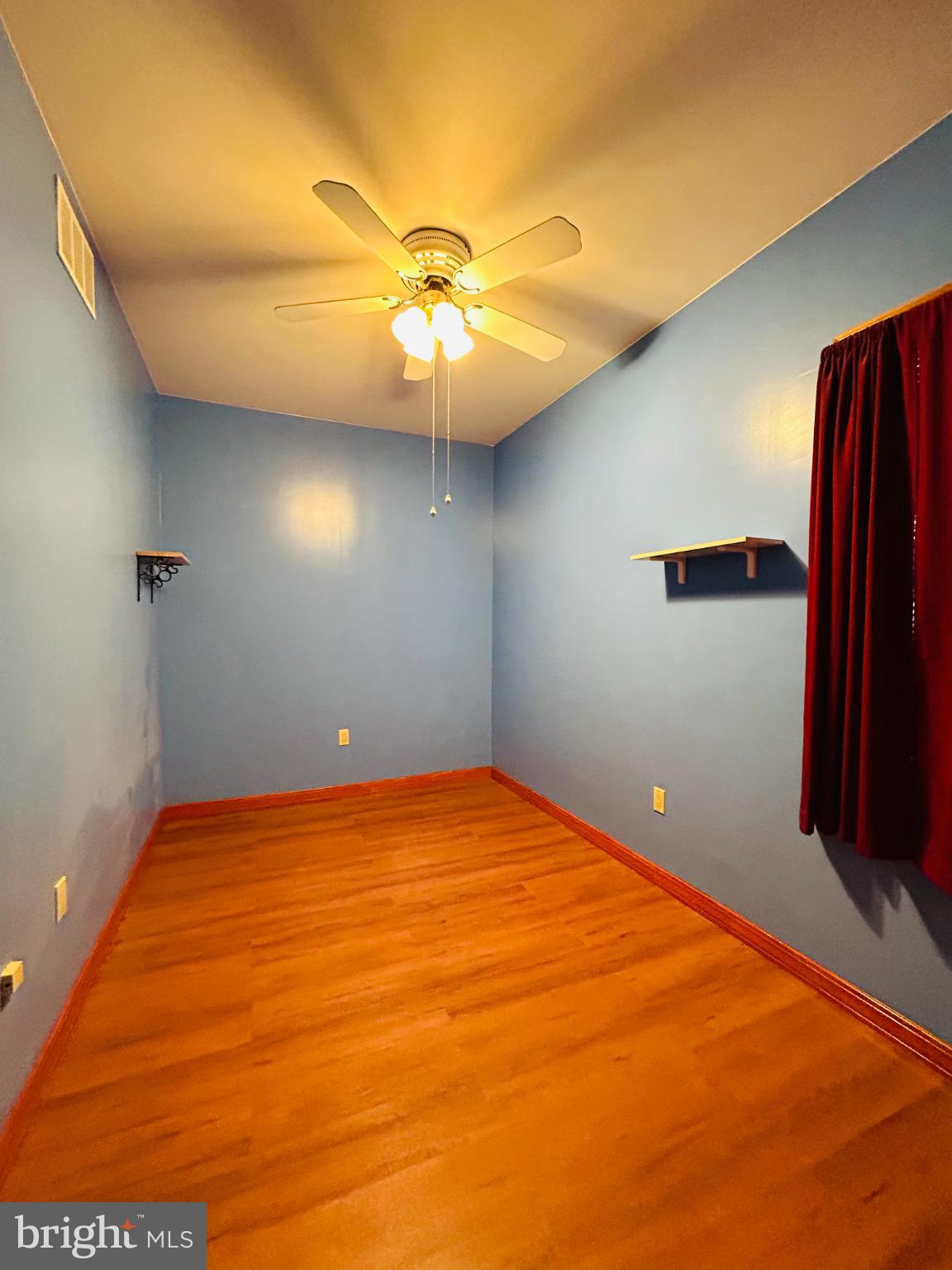 1507 West Shunk Street Philadelphia, PA 19145 - Photo 16 of 31 Bright blue room with wooden floors.