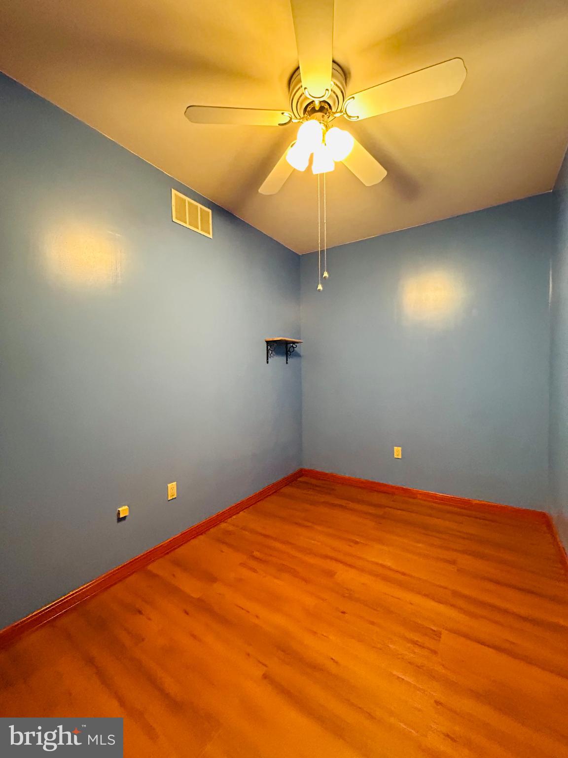 1507 West Shunk Street Philadelphia, PA 19145 - Photo 17 of 31 Bright blue room with warm wooden floors.