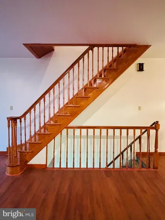 a view of staircase with railing and white walls