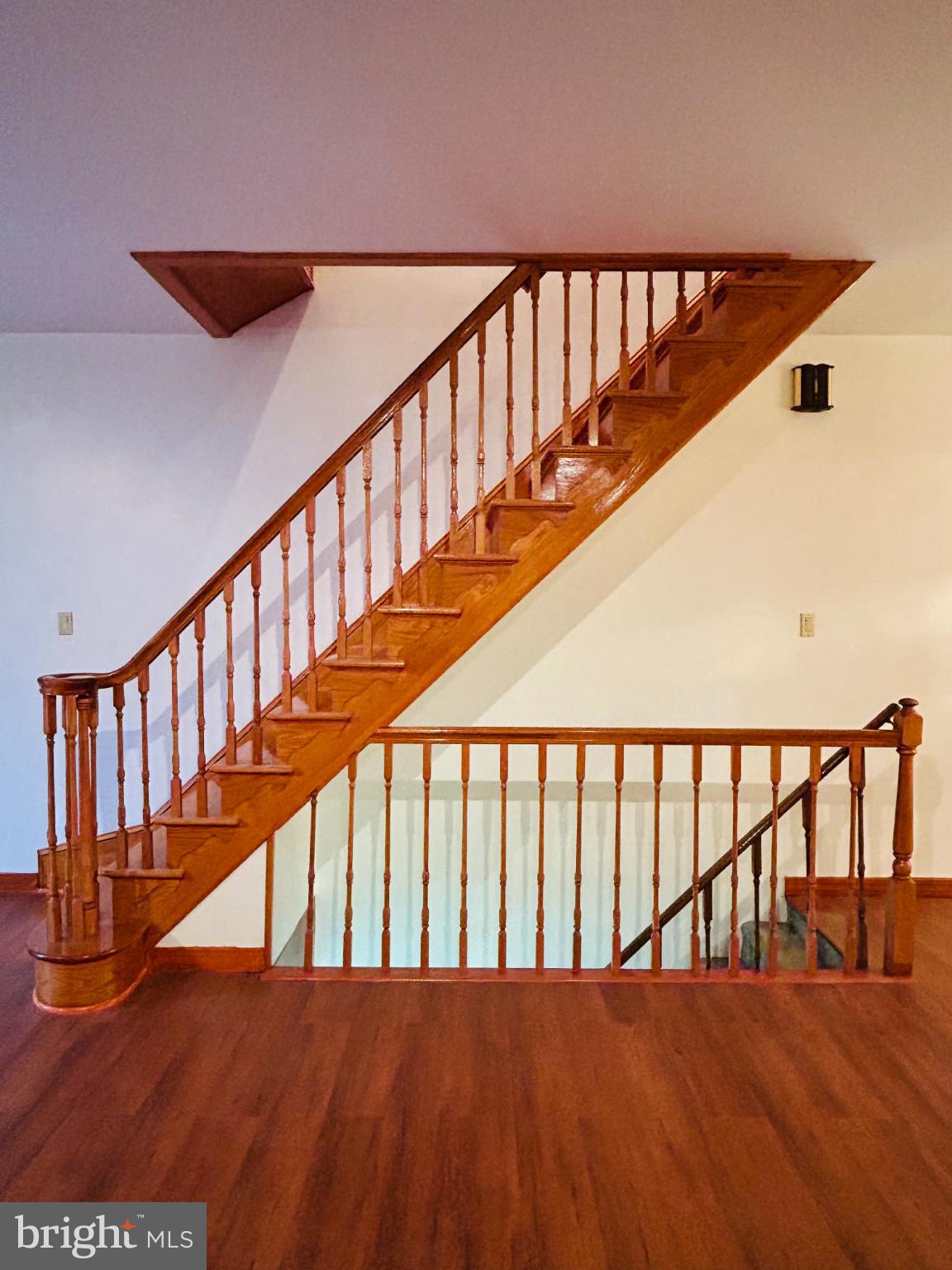1507 West Shunk Street Philadelphia, PA 19145 - Photo 3 of 31 Elegant wooden staircase with warm tones.