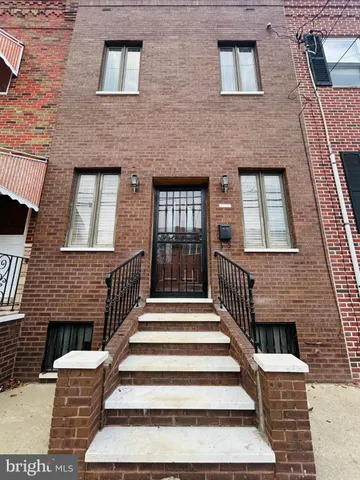a front view of a house with stairs