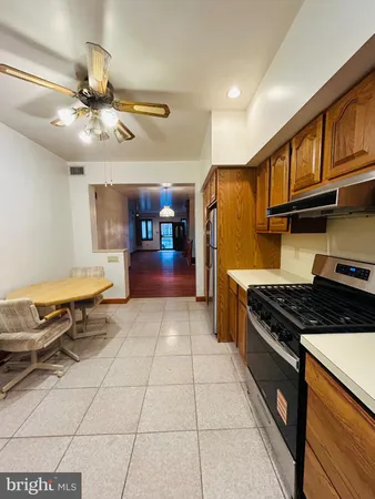 a kitchen with stainless steel appliances granite countertop a stove and a refrigerator