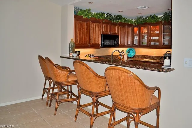 a kitchen with a table chairs and a microwave